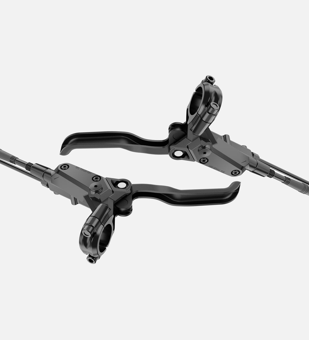 Close-up of high-performance hydraulic disc brake levers on an electric bicycle for precise control and reliable stopping power.