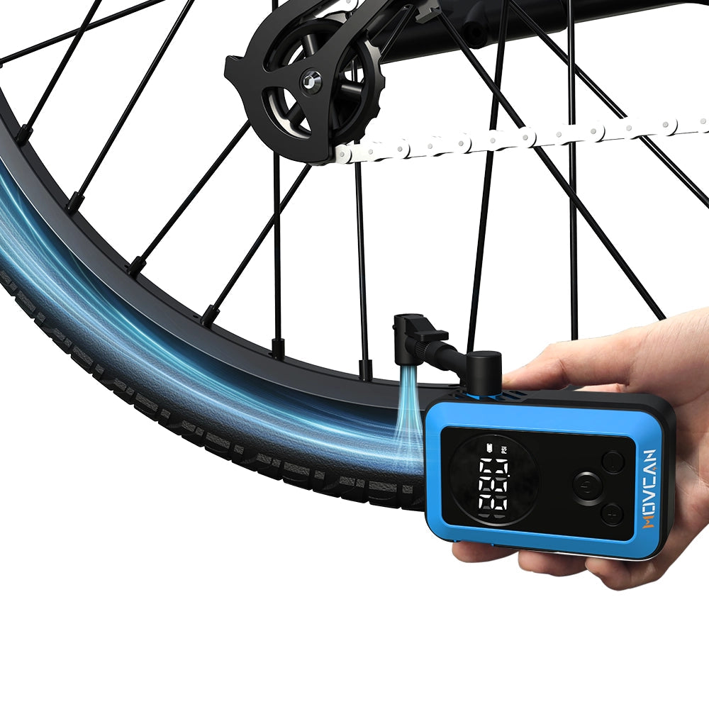 Compact mini electric air compressor held in hand showing lightweight and portable design for cycling travel
