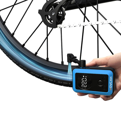 Compact mini electric air compressor held in hand showing lightweight and portable design for cycling travel